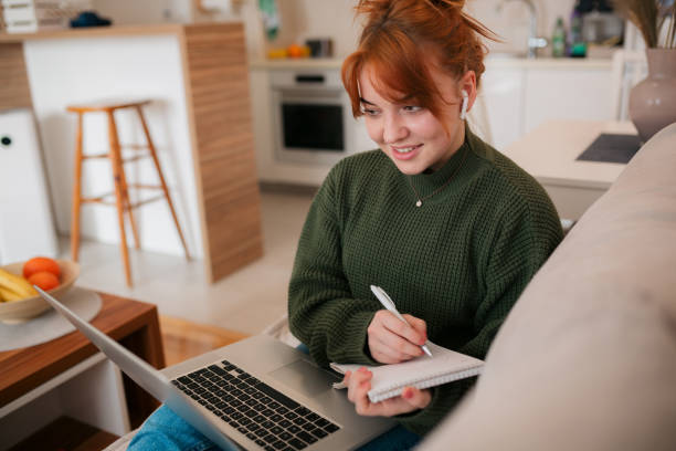 Young Caucasian woman using a laptop at home