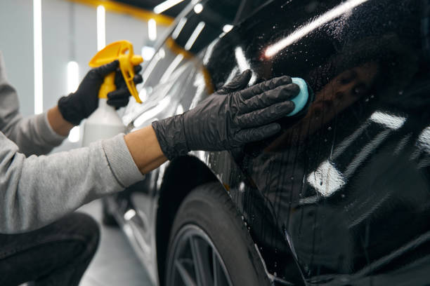 istock Experienced service station worker removing contaminants from automobile surface 1371972550