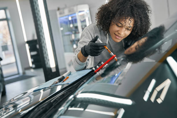 istock Joyous concentrated technician filling crack in windshield with liquid polymer 1371972705