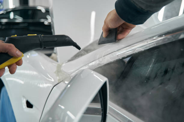 istock Worker is cleaning customer vehicle with steam-cleaner 1371972739