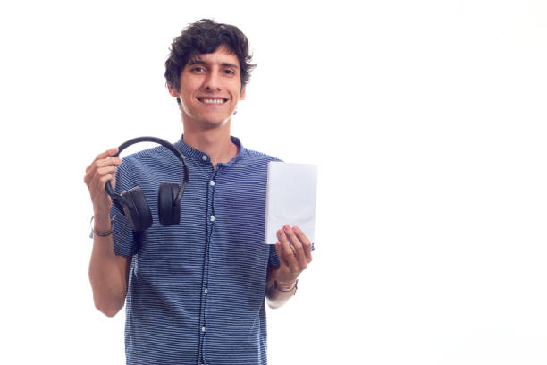 istock Young man learning with audiobook. Isolated on white background. 1371974904
