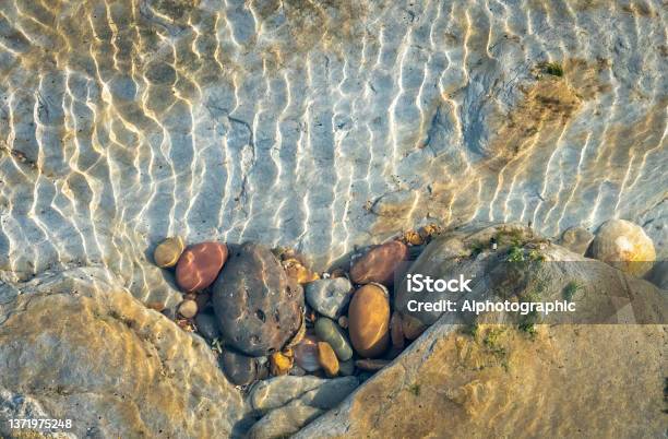 Coloured Pebbles In A Tidal Pool In The Rocks Near St Marys Island Stock Photo - Download Image Now