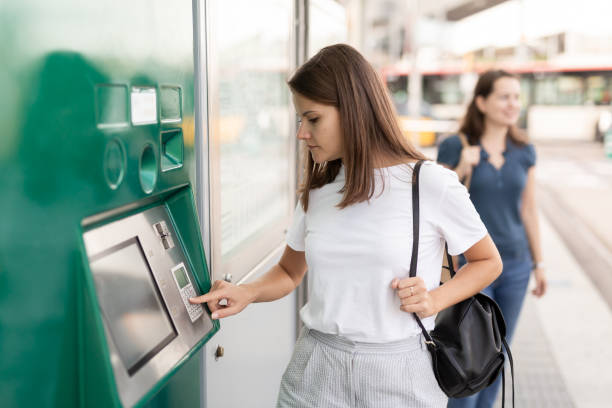 istock Brunette buying ticket for public transport 1371975486