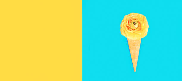 istock Cone ice cream with colorful flowers on blue background, blank copy space for advertising text 1371975646
