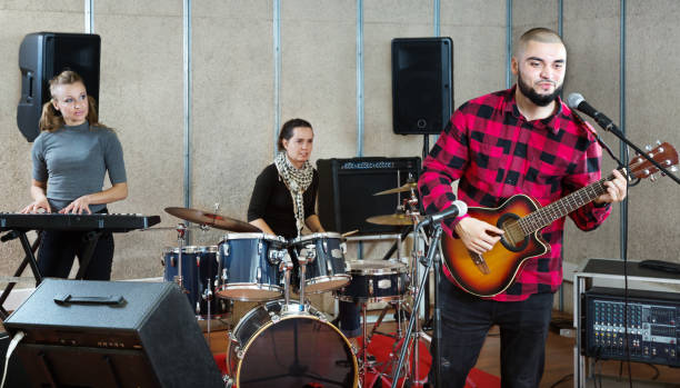 istock Bearded guy soloist playing guitar in studio 1371975894