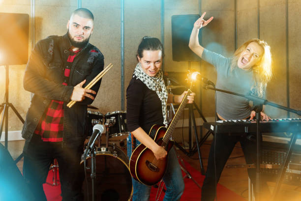 istock Three bandmates posing together with musical instruments in rehe 1371976428