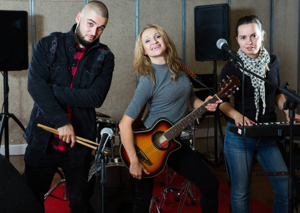 istock Joyful guitarist, drummer and keyboardist 1371976485