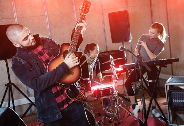 istock Guy guitar player and singer practicing with band members in re 1371976488