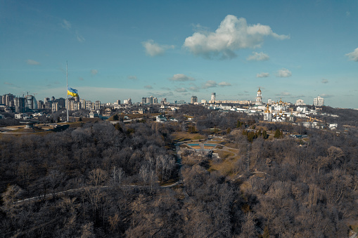 View of the main flag of the country and the Kyiv Pechersk Lavra and Singing field park in Ukraine.