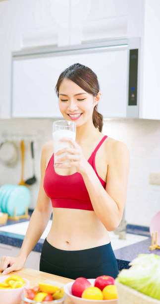 istock woman drinks milk in kitchen 1371977184