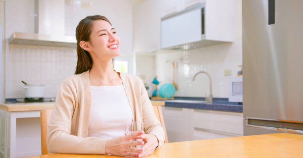 istock woman drink water at home 1371977315