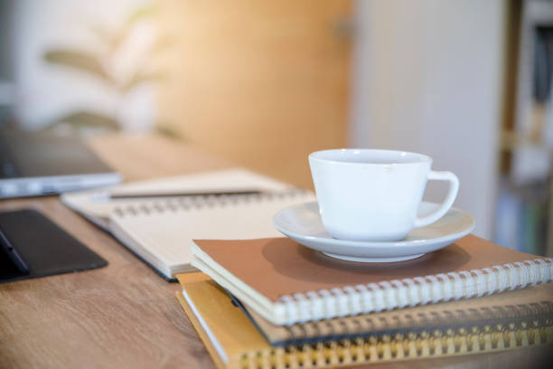istock Diary and Planner Book on School table for Student, study for exam. Wooden desk with laptop, tablet, notebook, cup of coffee, and pencil. Desk for student work at home concept. 1371978687
