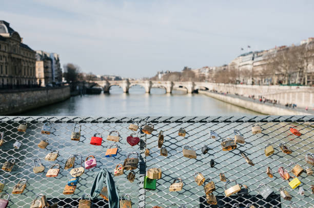 Padlocks on a bridge over the Seine river in Paris, France