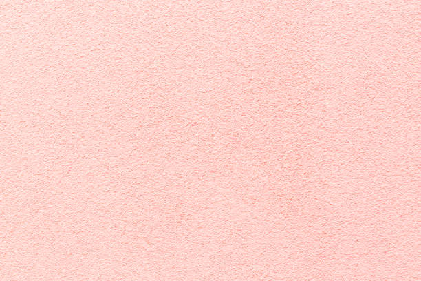 istock Sample of a texture of pink plaster. Wall finished with a decorative cement stucco. Example of exterior building decoration. Clean uniform grainy background. Banner. Wallpaper. Copy space. Pattern 1371980186