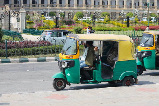 Bangalore or Bengaluru, Karnataka, India - February 5 2022: A selective focus of an auto rickshaw driver waiting for passengers at a stand. Bangalore or Bengaluru, Karnataka, India - February 5 2022: A selective focus of an auto rickshaw driver waiting for passengers at a stand. signs and symbols stock pictures, royalty-free photos & images