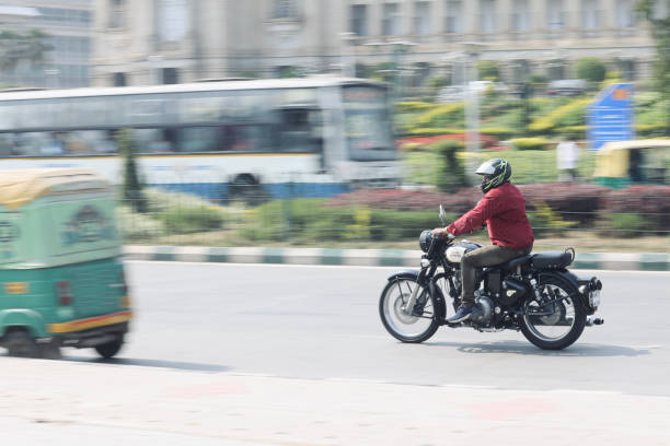 Panning Shot Bangalore or Bengaluru, Karnataka, India - February 5 2022: A selective focus of panning shot of a Royal Enfield Motorcycle along with the rider. signs and symbols stock pictures, royalty-free photos & images