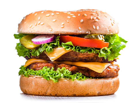 Hamburger with cheese and fresh vegetables isolated on white.