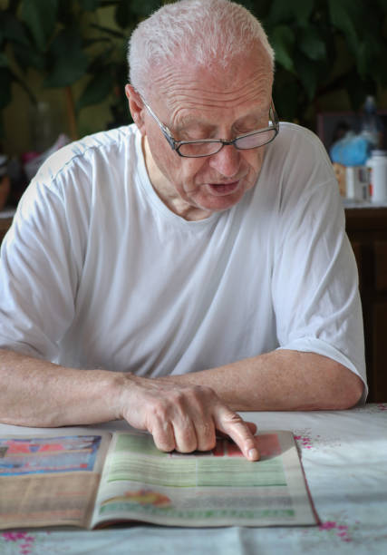 istock Old Gray Hair Man Reading 1371981193