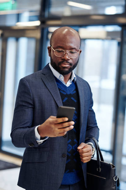 istock Businessman checking the message on his mobile phone 1371981541
