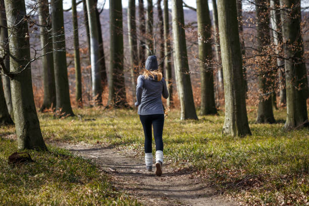 istock Woman running in forest 1371982874