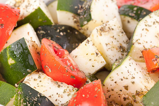 Sliced courgette and tomato ready for roasting stock photo