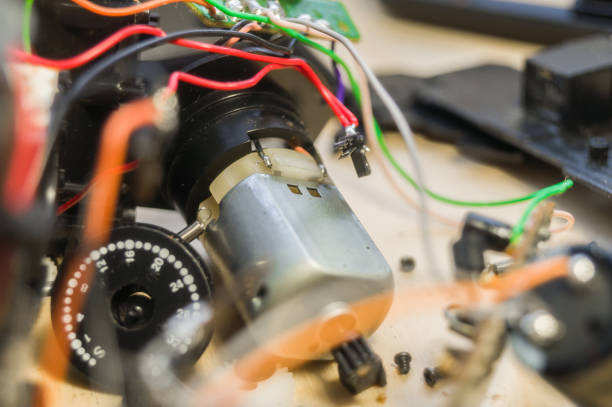 istock Compact electric motor. Repair of consumer electronics. Workflow in the workshop of electrical appliances. Electronic components and parts disassembled. Selective focus, background 1371985287