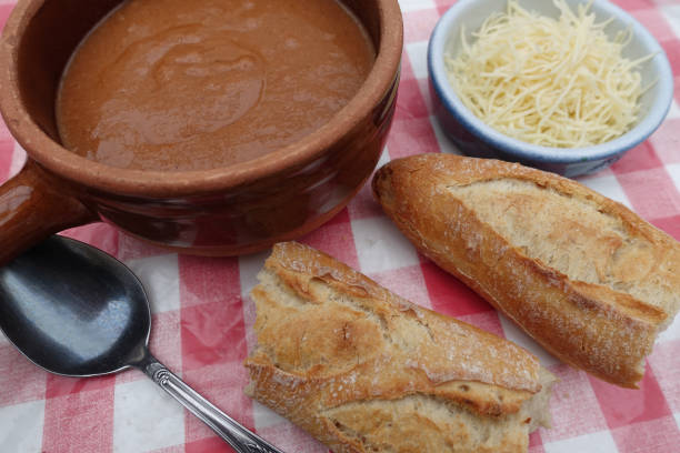 istock Fish soup before gratin Baguette bread and grated Gruyere cheese on a kitchen worktop 1371985521