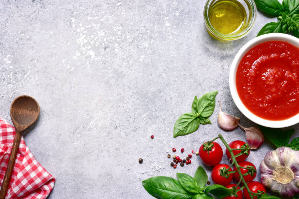 istock Homemade tomato sauce with ingredients for making. Top view with copy space. 1371986689