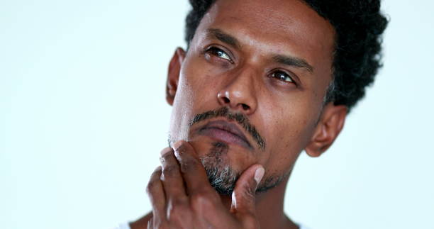 istock Pensive African man close-up face portrait. Thoughtful black person thinking about solution 1371987028