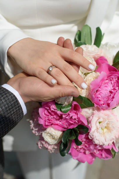 istock Newly wed couple's hands with wedding rings 1371987536