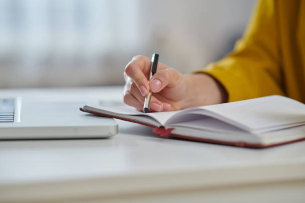 istock Close up of a womans hand making notes 1371988981