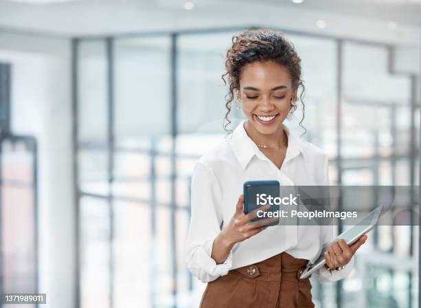 Cropped Shot Of An Attractive Young Businesswoman Sending A Text While Working In Her Office Stock Photo - Download Image Now