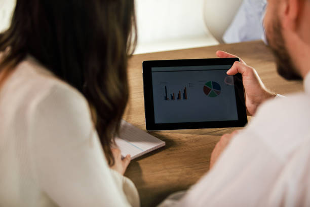 istock Two business colleagues reviewing charts and graphs on a digital tablet 1371989099