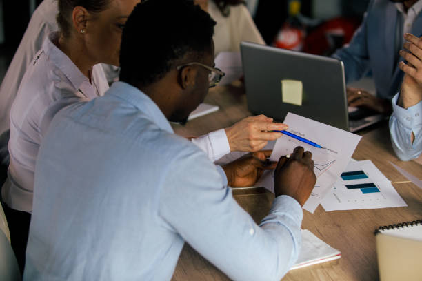 istock Two business people reviewing a graph document during a corporate meeting 1371989141