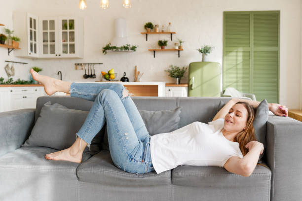 istock Young attractive woman relaxing on sofa at home 1371990515