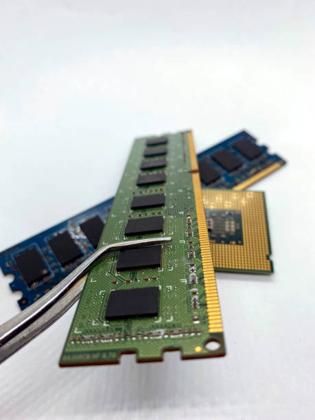 istock RAM chip on pincer closeup with other chips on white background 1371990630