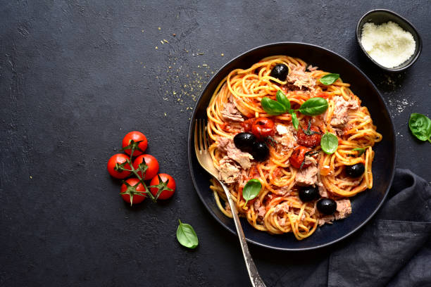 istock Pasta spaghetti with tuna, tomatoes and olives. Top view with copy space. 1371991216