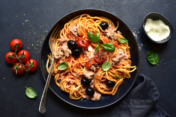 istock Pasta spaghetti with tuna, tomatoes and olives. Top view with copy space. 1371991242
