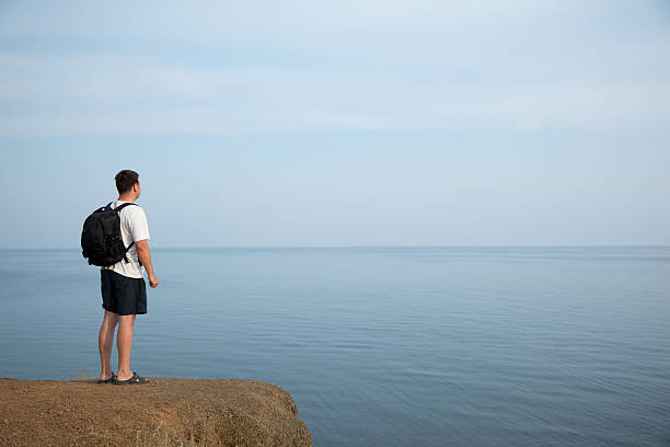 mann, blick auf das meer - golden cap stock-fotos und bilder