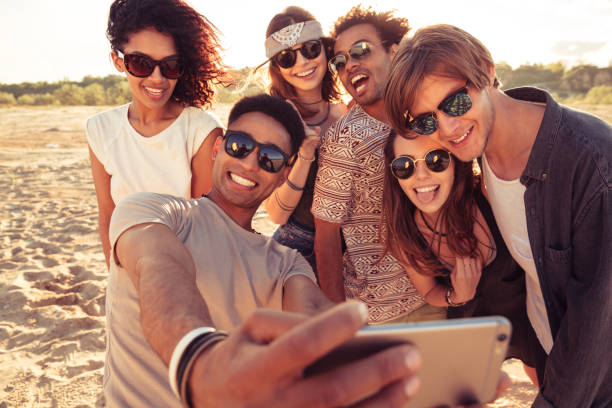 istock Excited young friends on the beach make selfie 1371991476