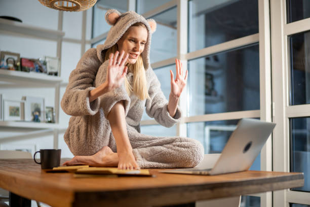 Missing a friend during lockdown. Woman doing video call in cute bear onesie