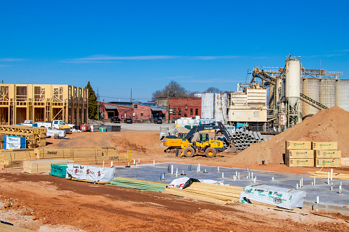Athens, Georgia - January 30, 2022: Construction on The Mill District, a mixed-use development, is visible in foreground with the Argos concrete plant and Chase Street Warehouse complex visible just beyond.