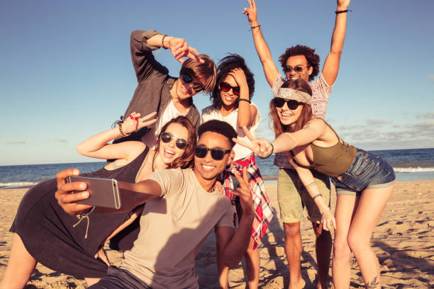 istock Excited young friends on the beach make selfie 1371992858