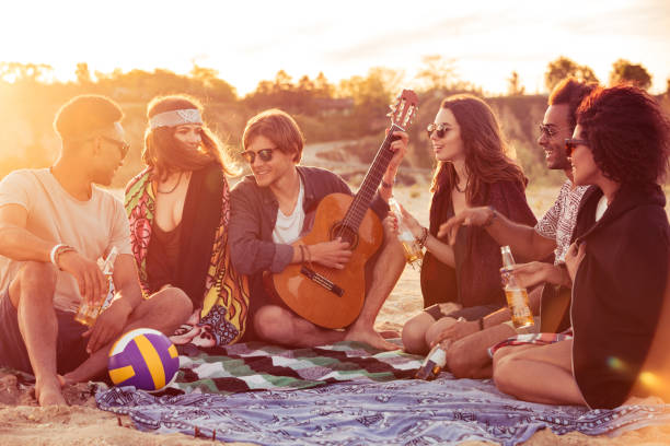 istock Young group of friends outdoors on the beach 1371992911