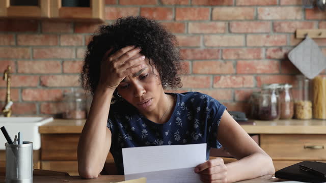 Young Black lady open letter feel stressed with bad news