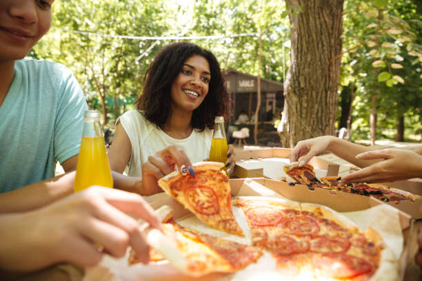 istock Friends sitting by the table in forest 1371993422