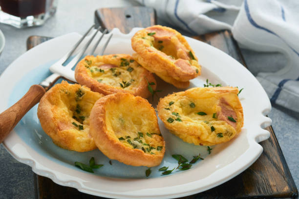 istock Egg muffins with green onions, bacon, cheese and tomatoes on white plate on light background. Healthy high protein and low carb breakfast, ready to eat. 1371994322