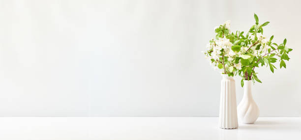 istock Spring flowers in a vase on a white table. Easter background with copy space 1371994605
