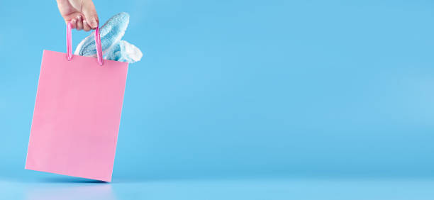 istock Wide banner on a blue background. Gift bag in hand. 1371995640