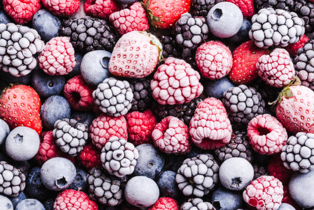 Frozen berries fruits background. Frozen berries fruits background close up.Fruits with frost. frozen food stock pictures, royalty-free photos & images
